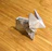 Close-up of delicate paper toy animals arranged on a wooden table.
