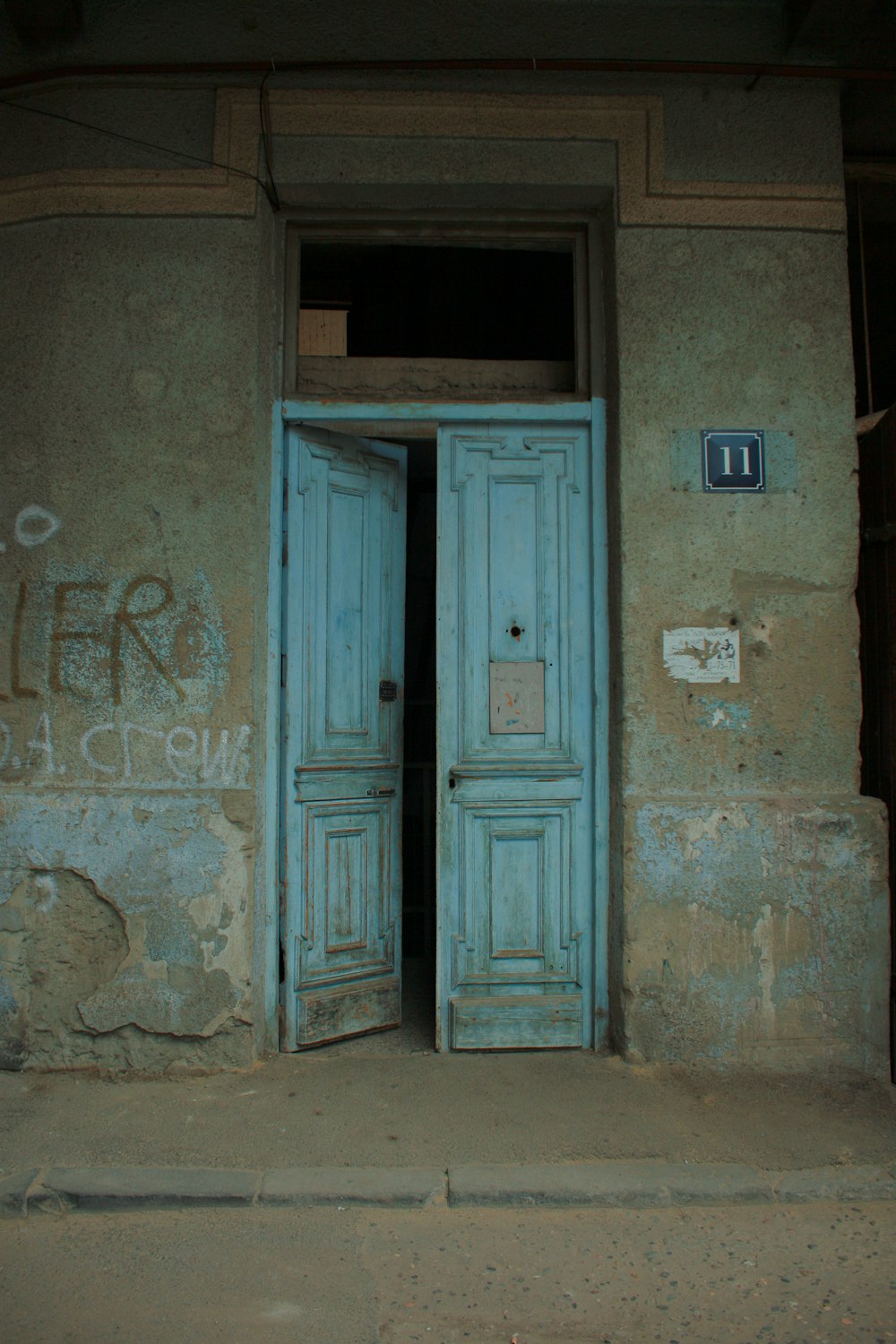 two blue doors are open in an old building