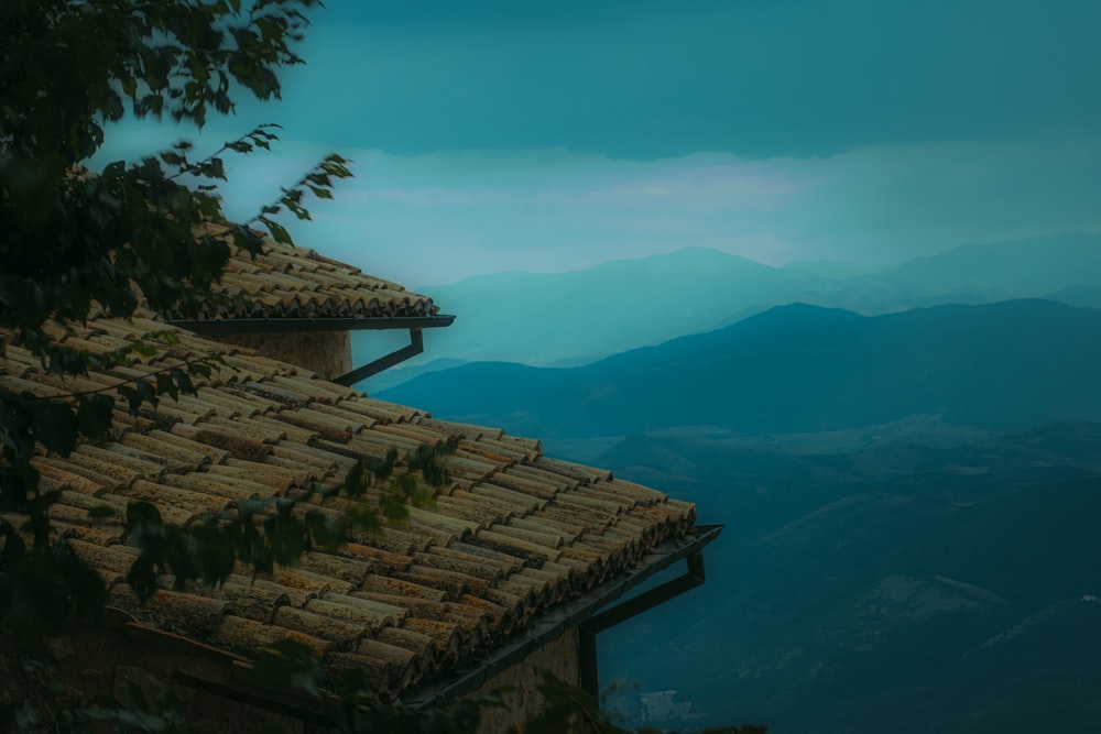 a view of a roof with mountains in the background