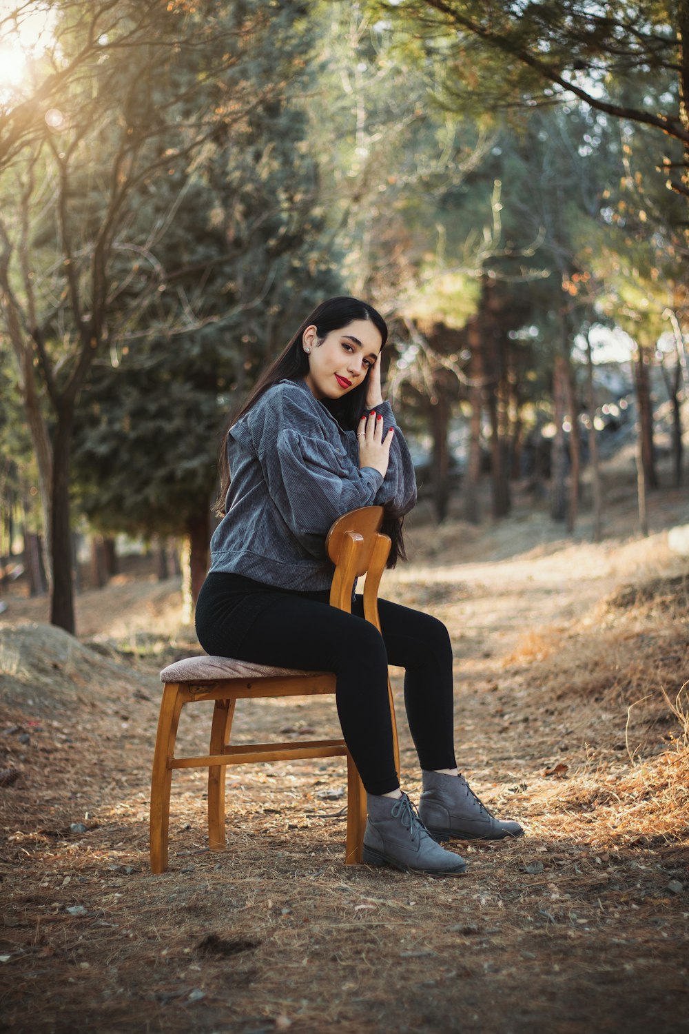 a woman sitting on a chair talking on a cell phone