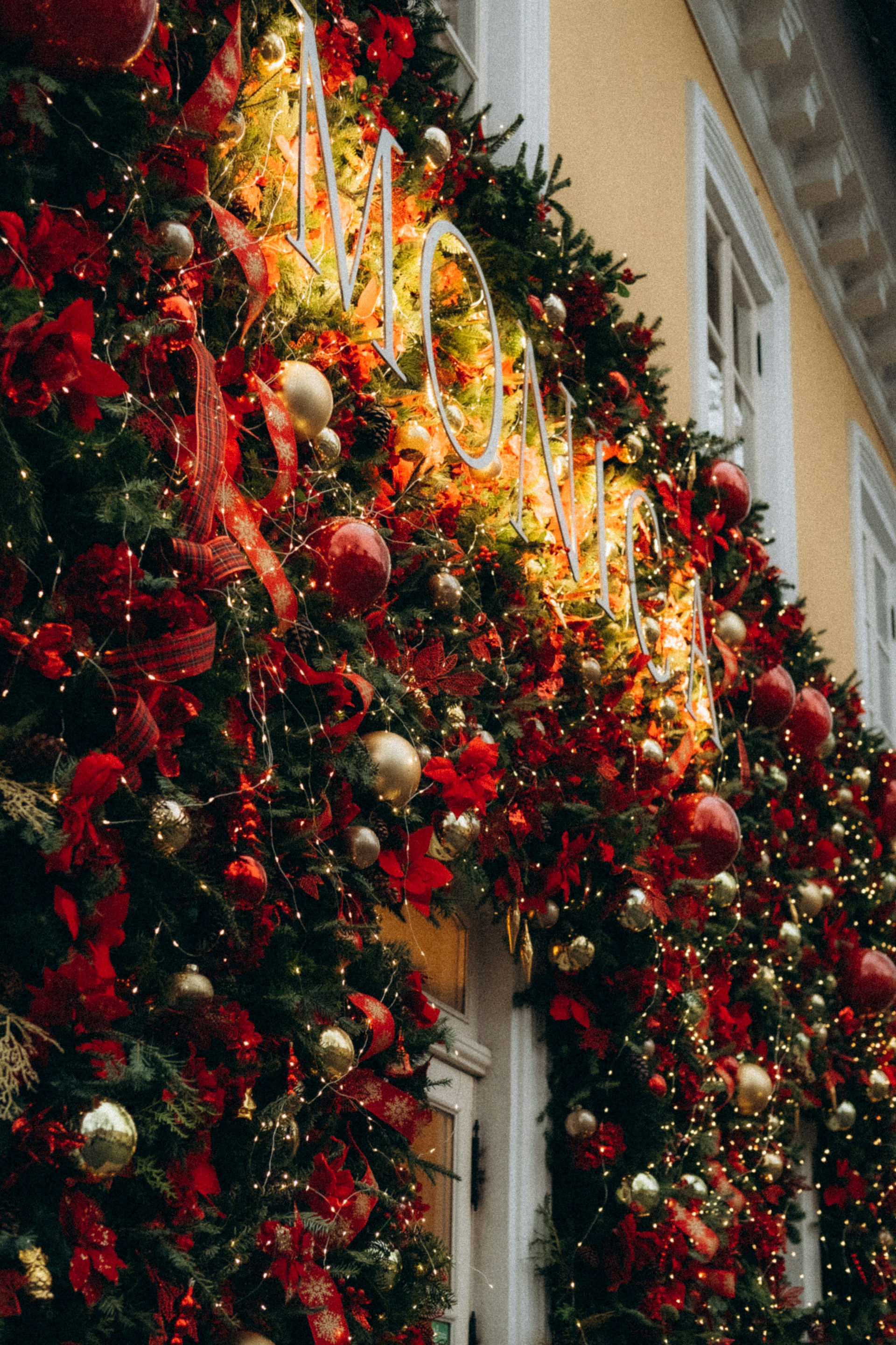 a decorated christmas tree outside of a building