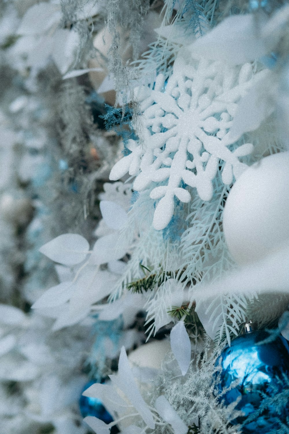 a blue and white christmas tree with snowflakes