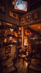 A cozy room filled with vintage decorative items like ornate vases, antique clocks, and weathered picture frames.