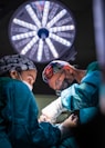 two surgeons performing surgery on a patient in a hospital