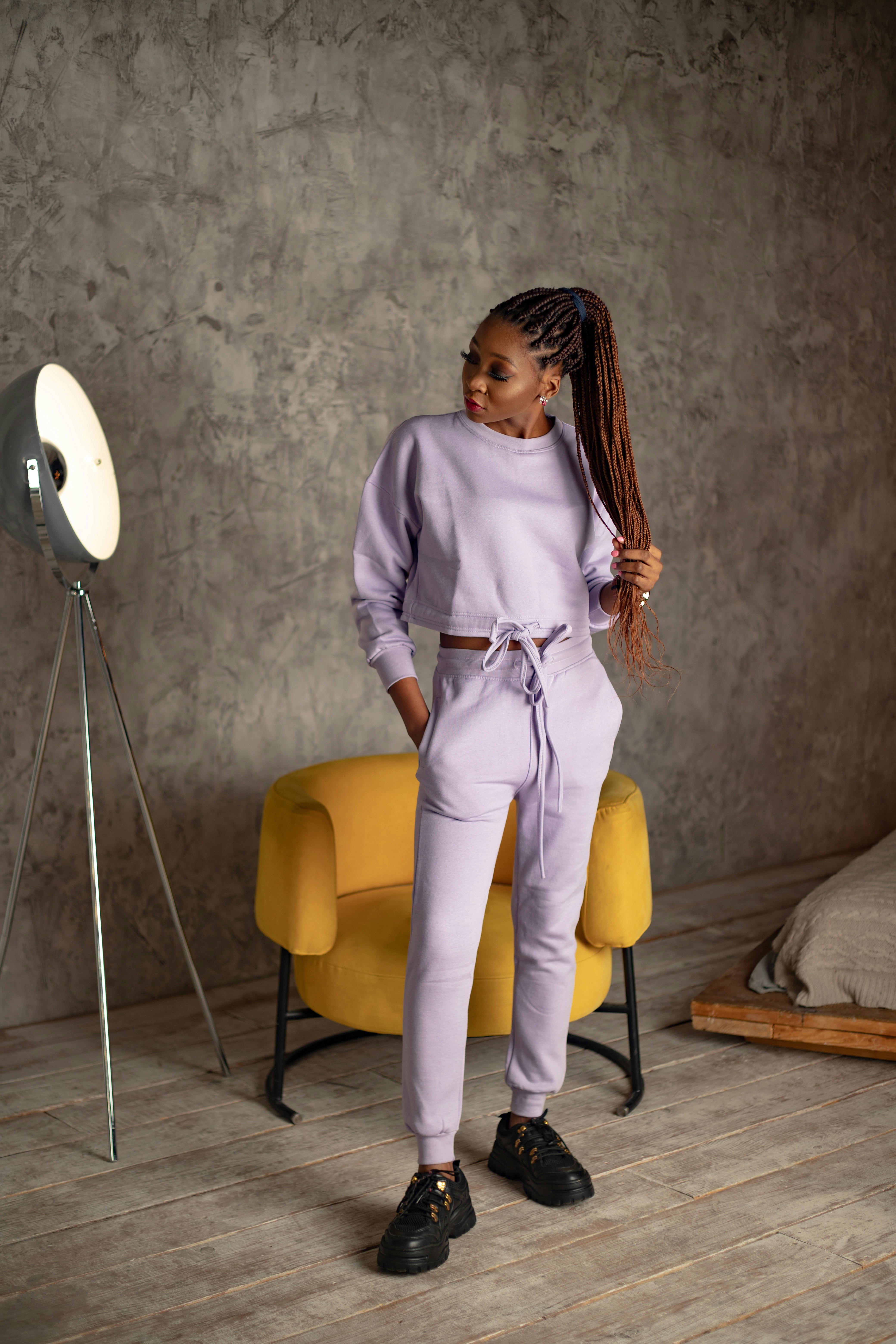 A woman standing in a room with a yellow chair