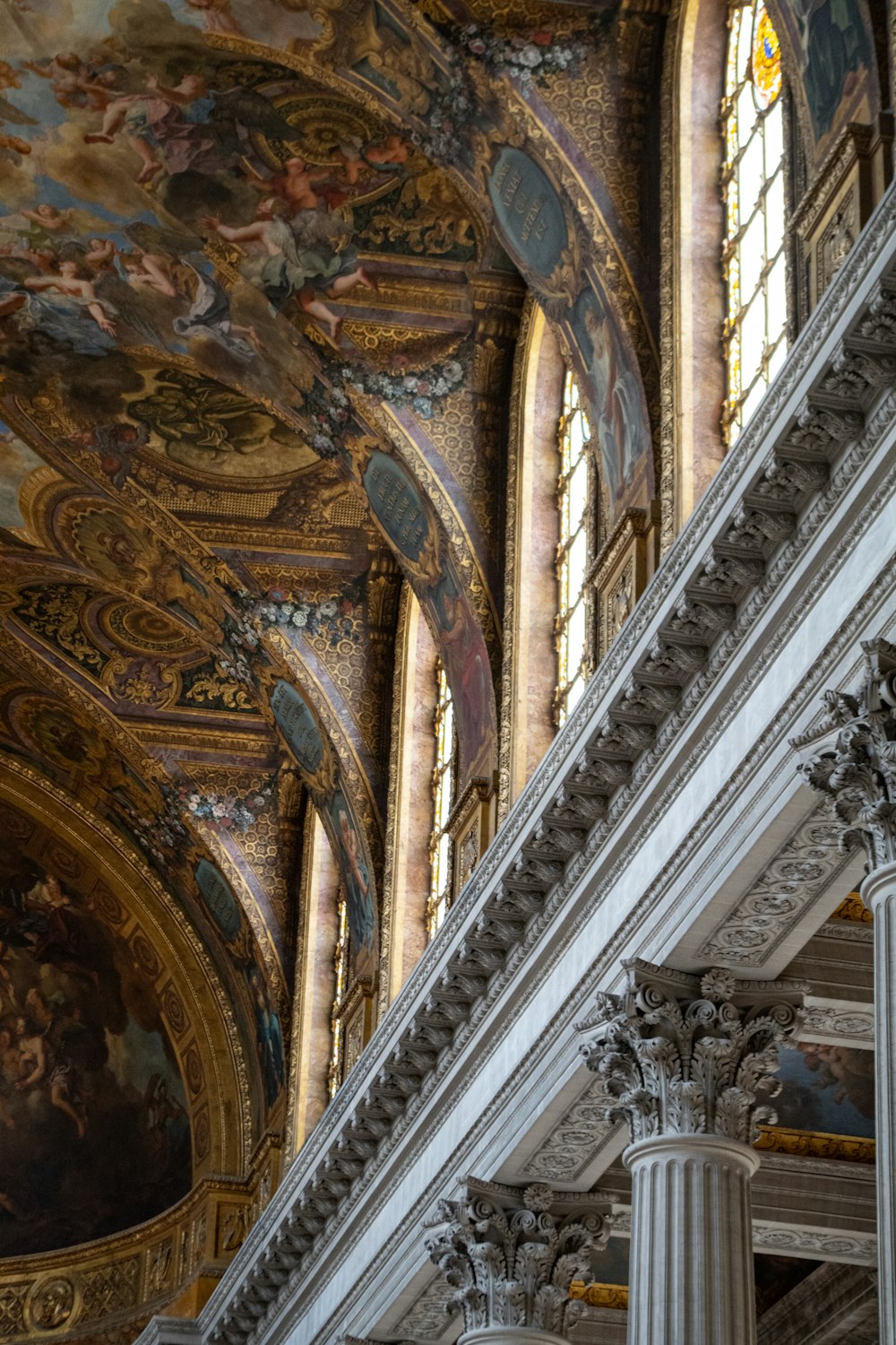 the ceiling of a building with many paintings on it