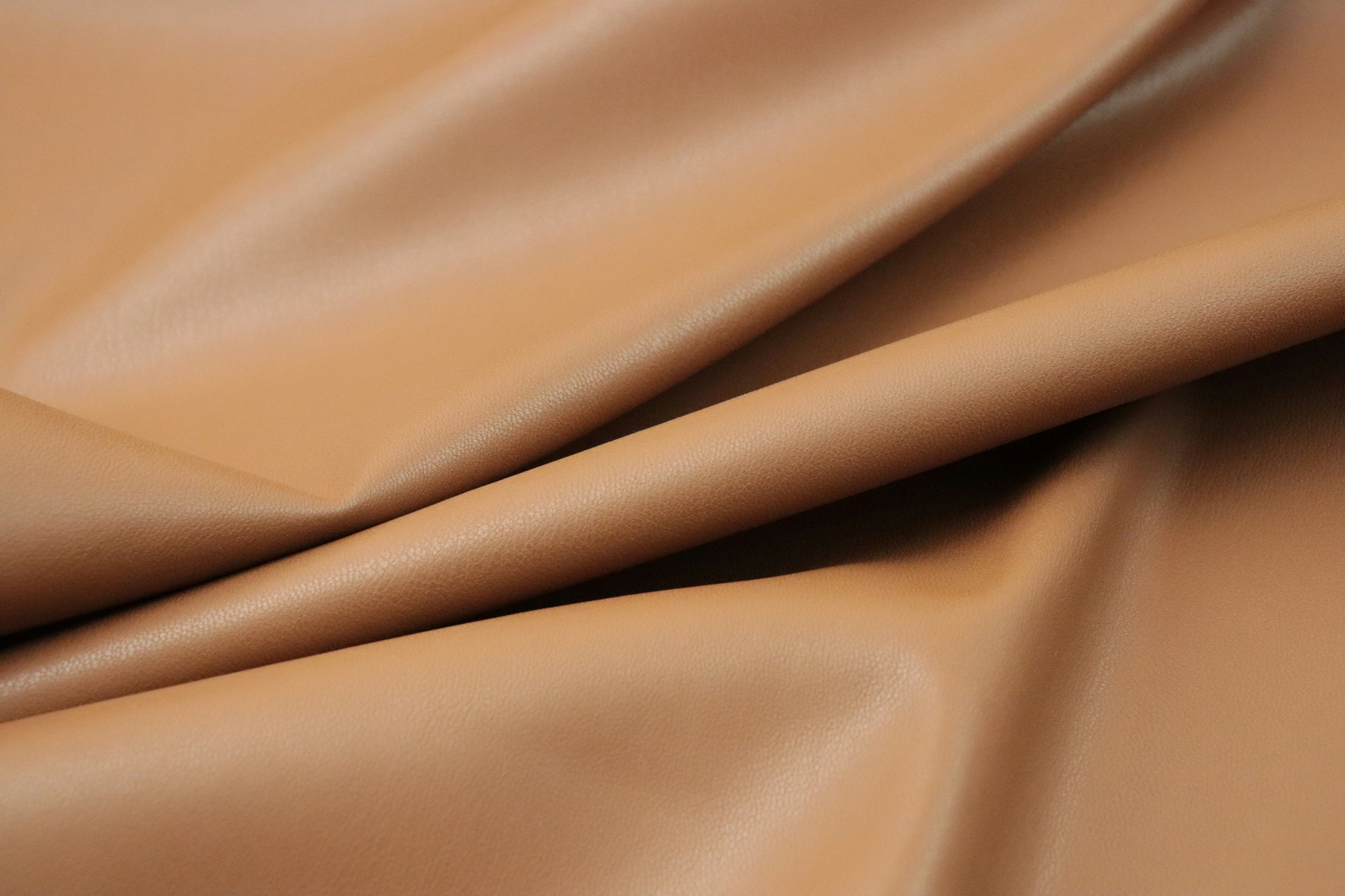 a close up of a tan leather texture