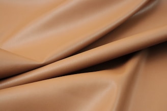 a close up of a tan leather texture