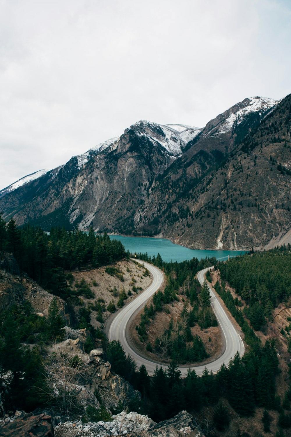 a scenic view of a winding road in the mountains