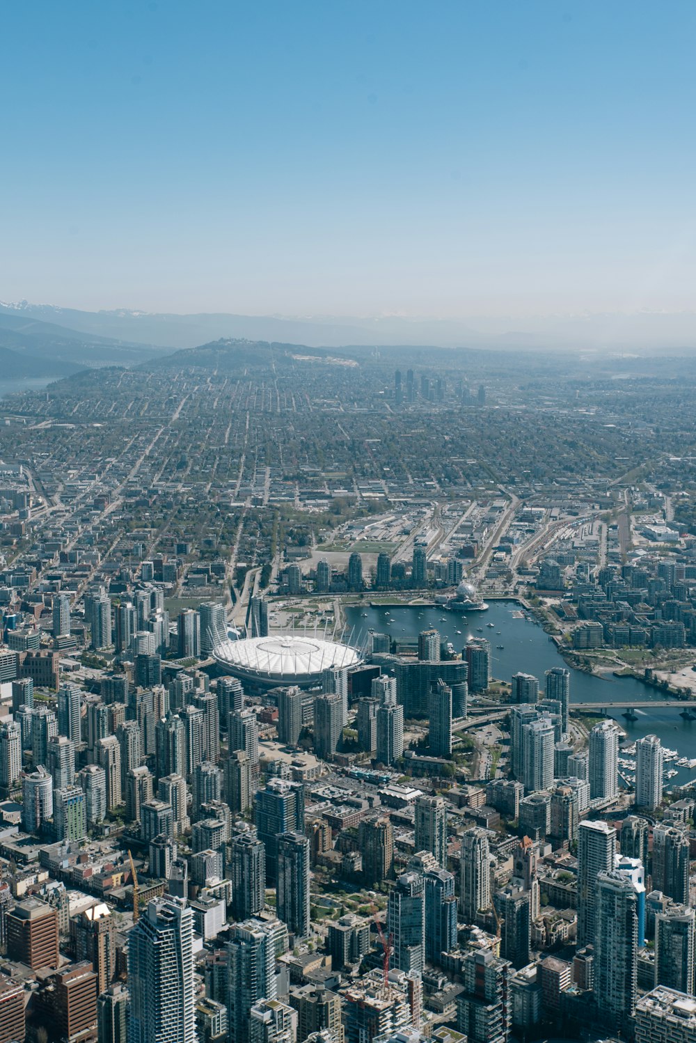 an aerial view of a city and a lake