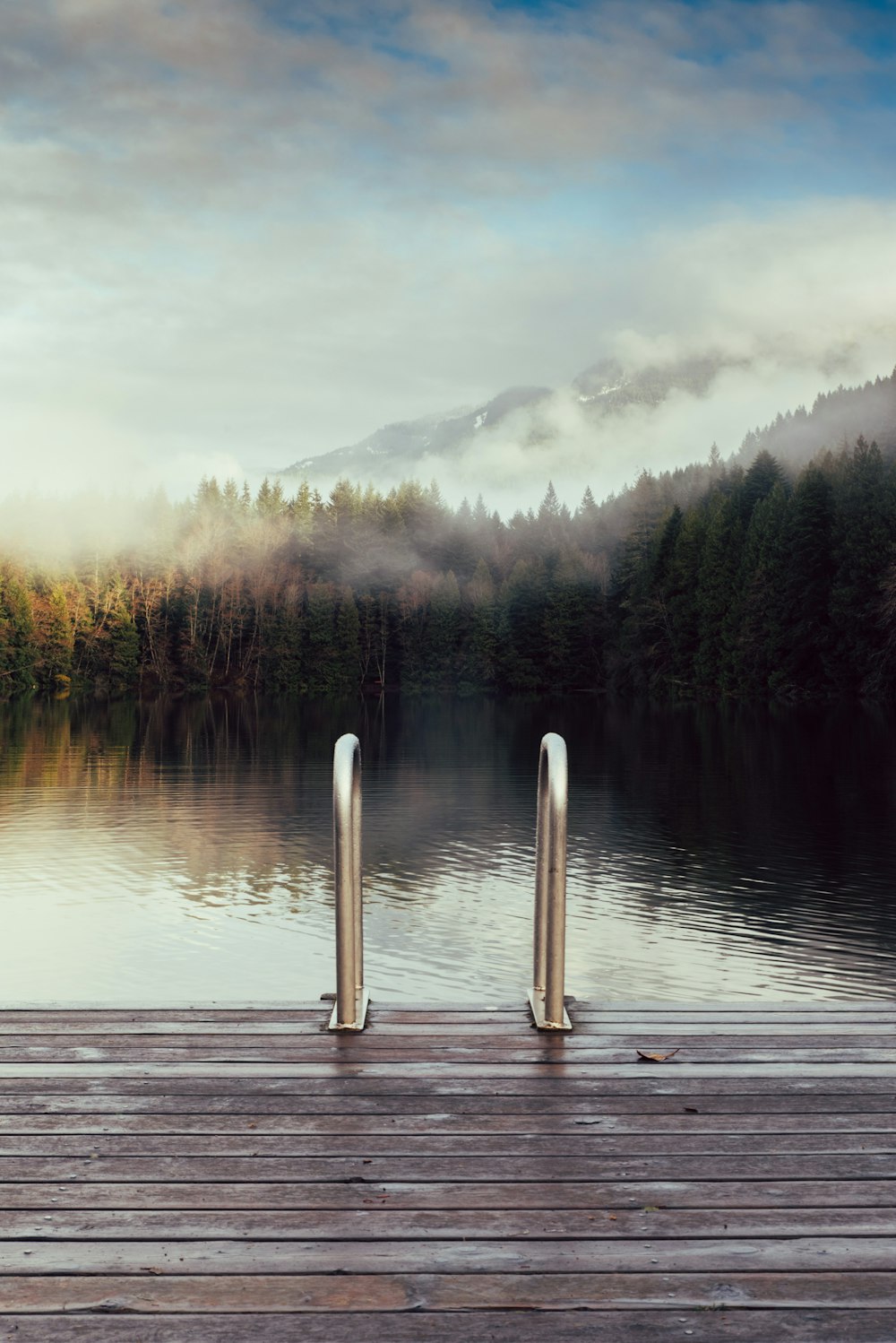 a wooden dock with two metal posts on it