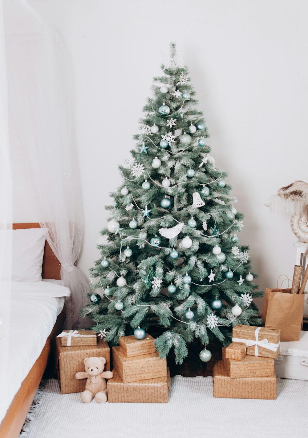 a small christmas tree with presents under it