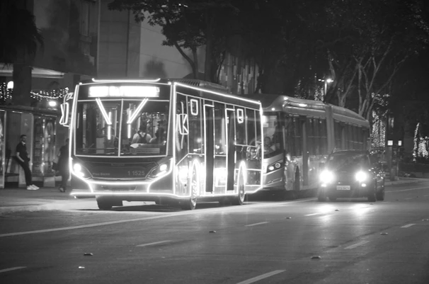Night view of an HSRP bus illuminated under streetlights, showcasing safety and service.