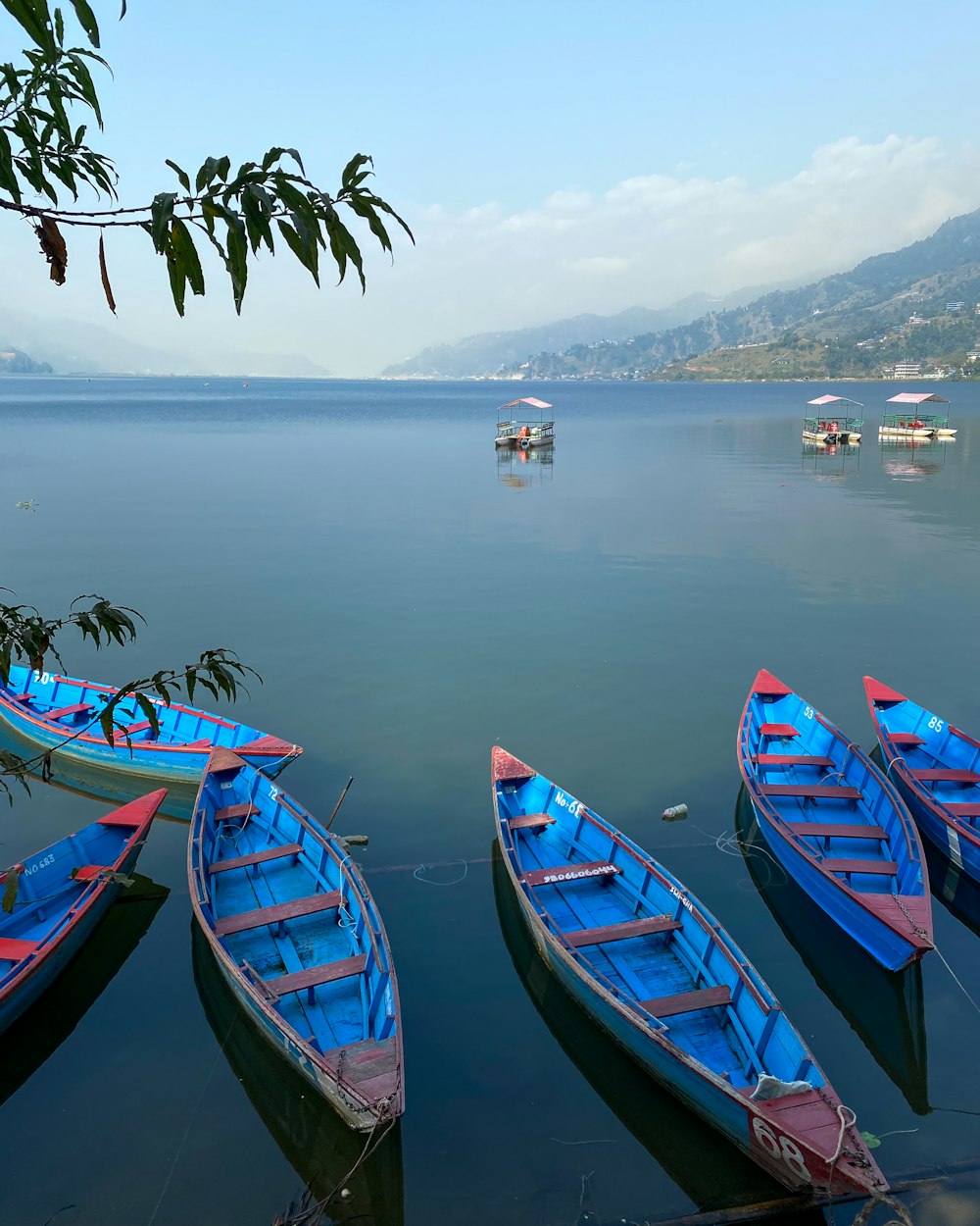 a group of boats floating on top of a lake