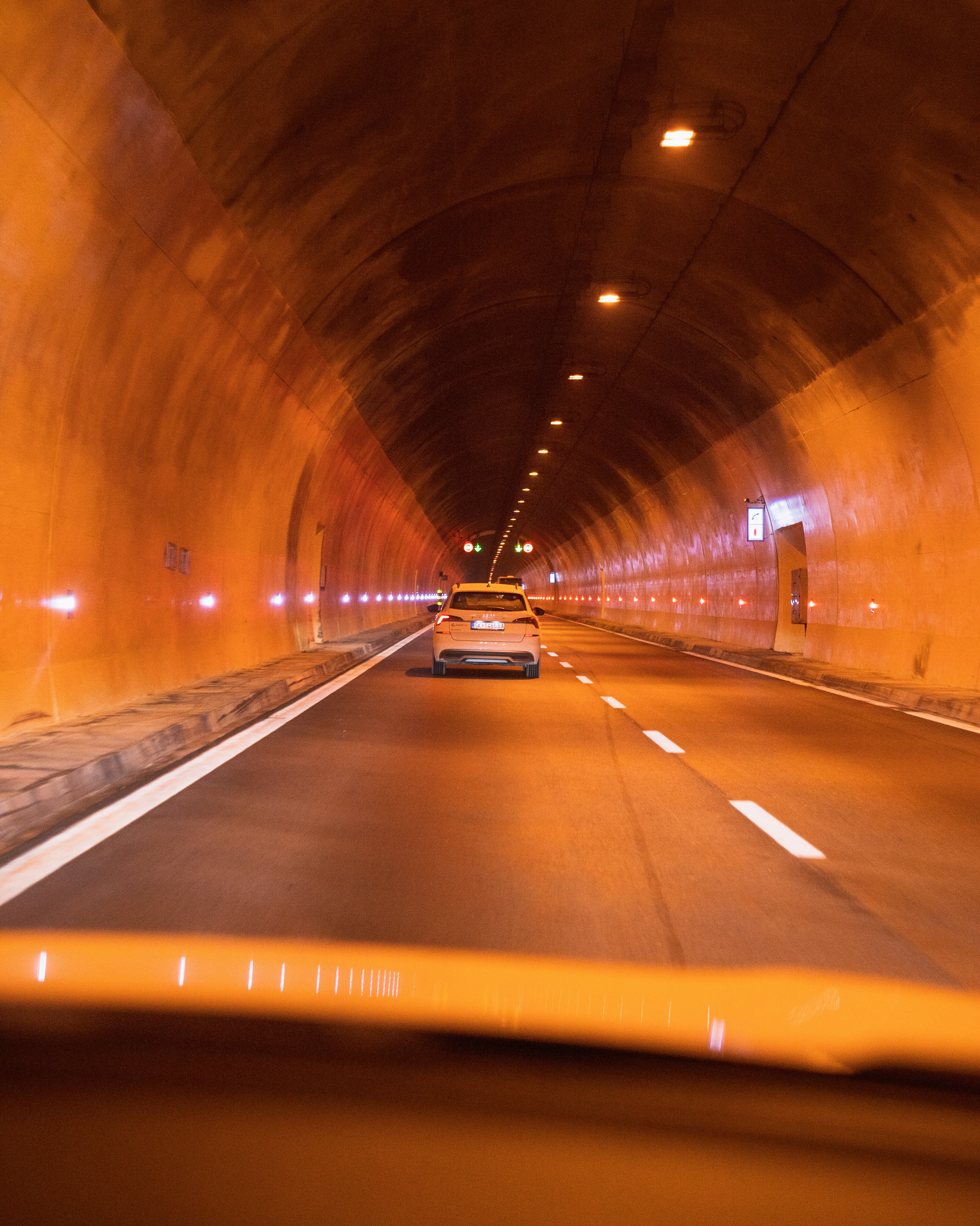 a car driving through a tunnel on a highway