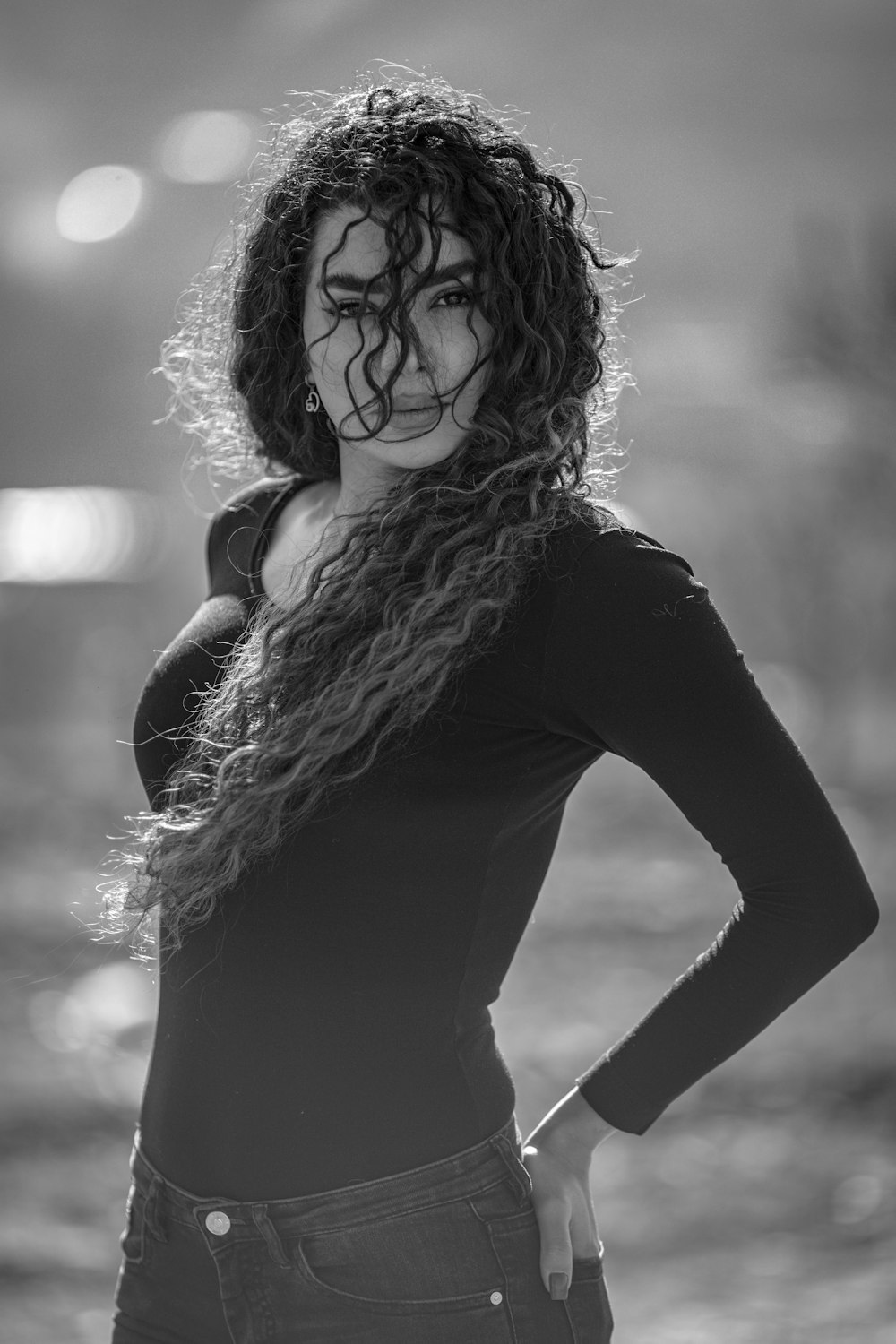 a black and white photo of a woman with curly hair