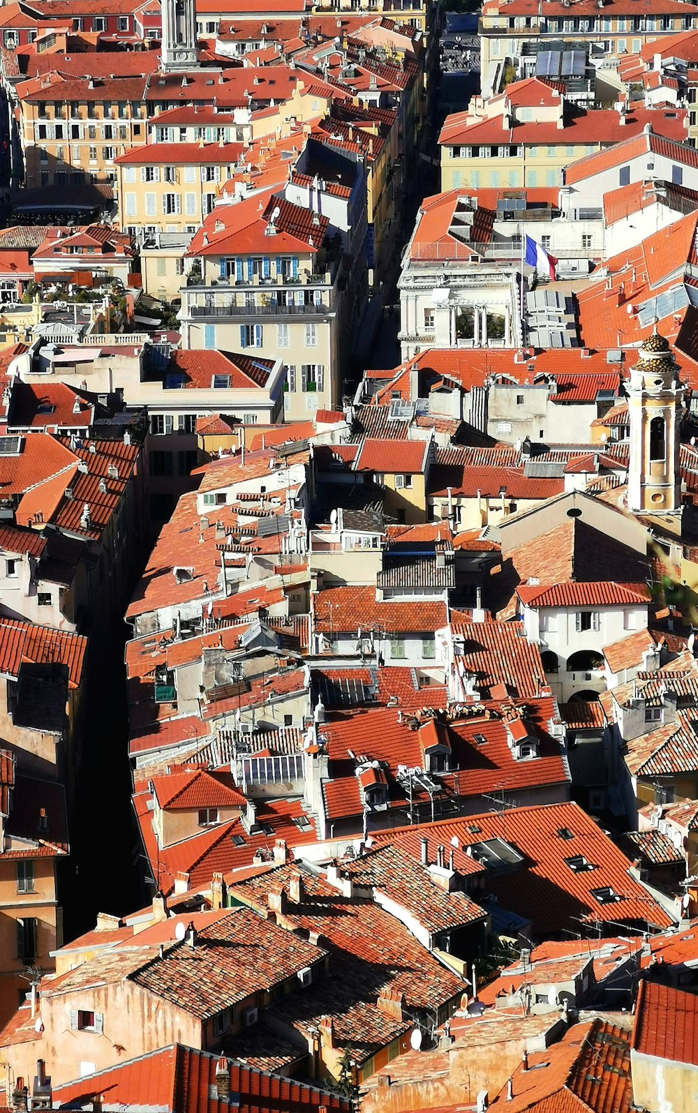 an aerial view of a city with red roofs