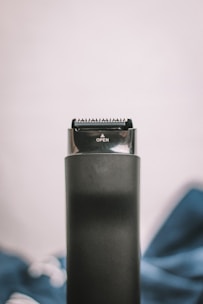 a close up of a hair dryer on a bed