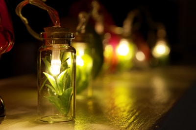 A collection of slime jars lined up, each glowing under blacklight.