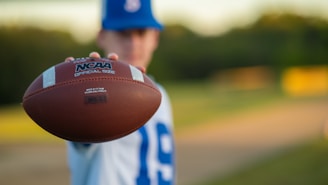 a close up of a person holding a football