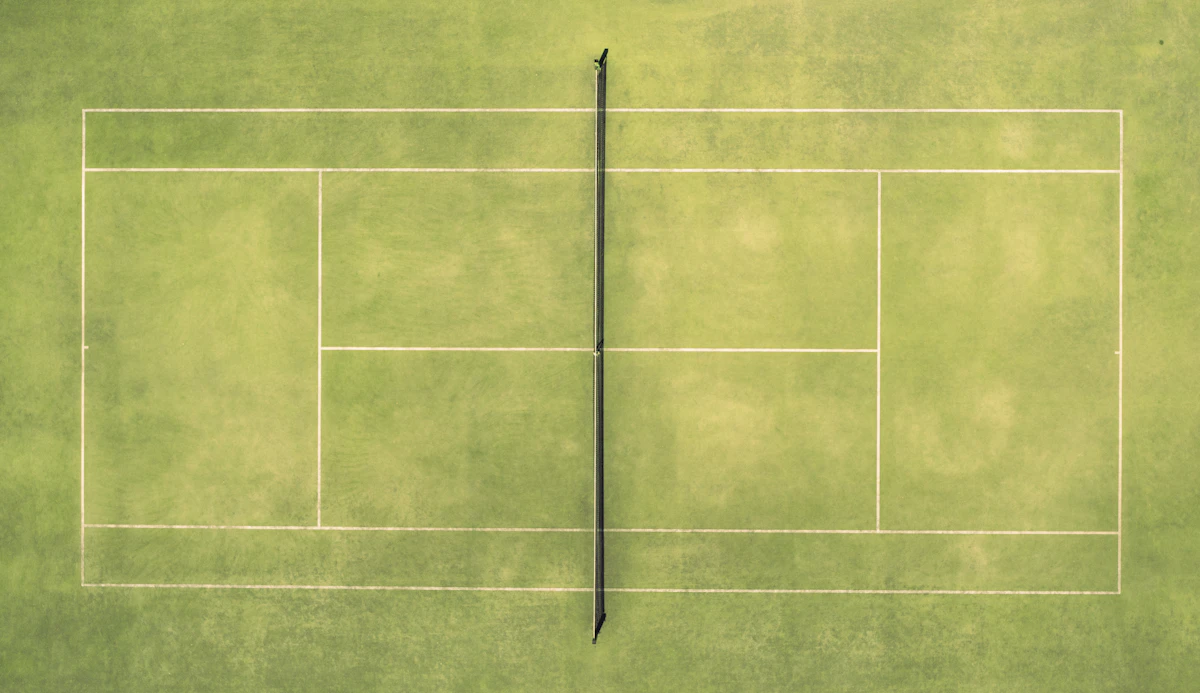 Aerial view of a tennis court with a racket and ball. Stock photograph.