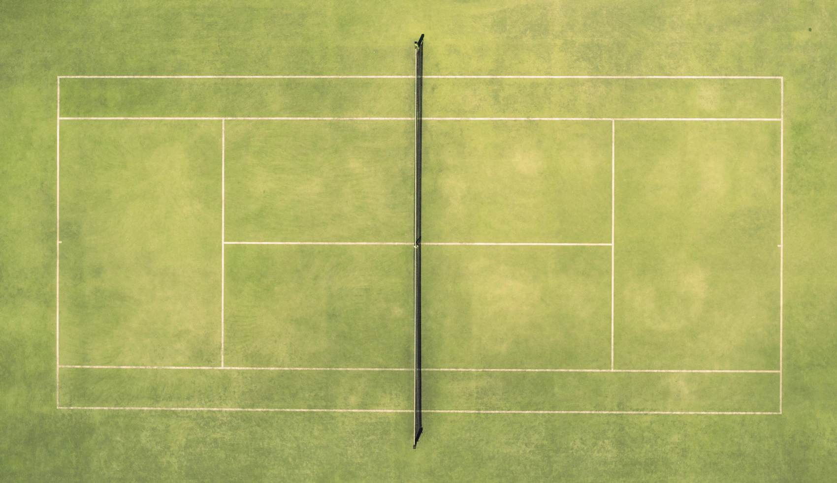 Aerial view of a tennis court with a racket and ball. Stock photograph.
