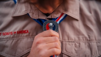 a close up of a person tying a tie