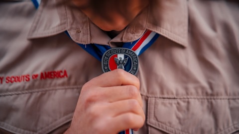 a close up of a person tying a tie