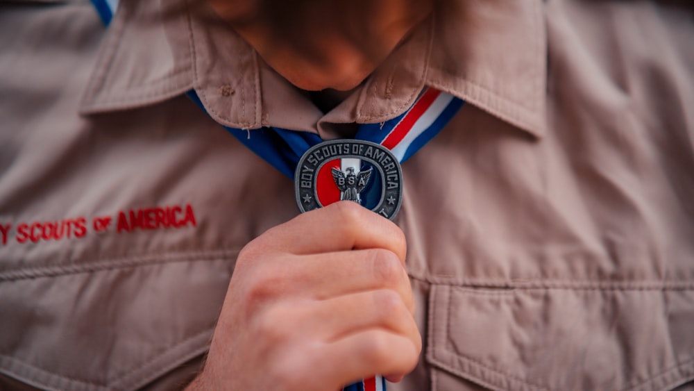 a close up of a person tying a tie