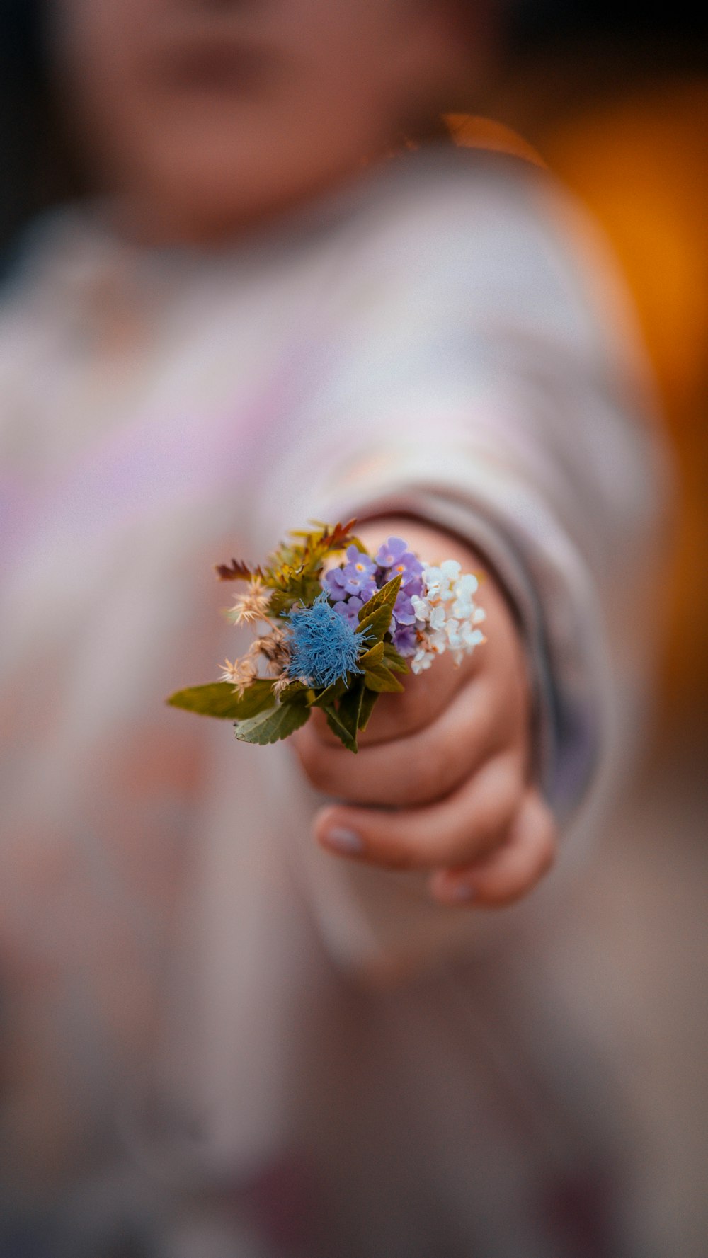 a person holding a flower in their hand