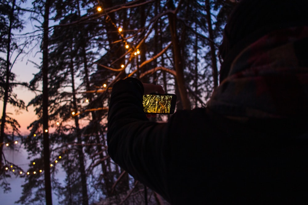 a person taking a picture with a cell phone