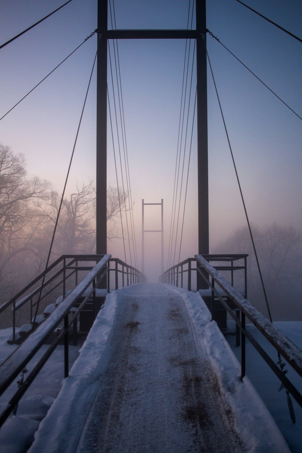 a bridge that has snow on the ground