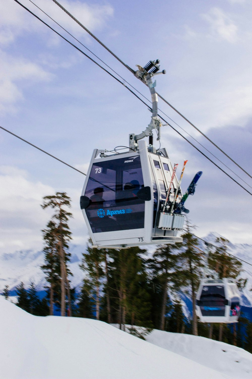 a ski lift going up a snowy mountain