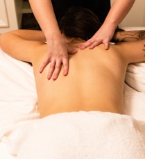 a woman getting a back massage at a spa