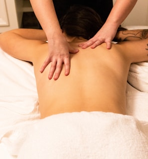 a woman getting a back massage at a spa