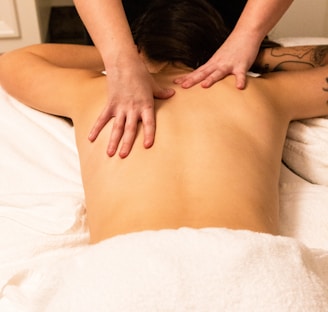 a woman getting a back massage at a spa