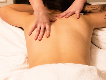 a woman getting a back massage at a spa