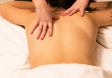 a woman getting a back massage at a spa