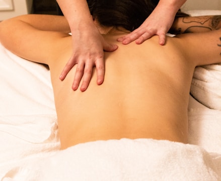 a woman getting a back massage at a spa