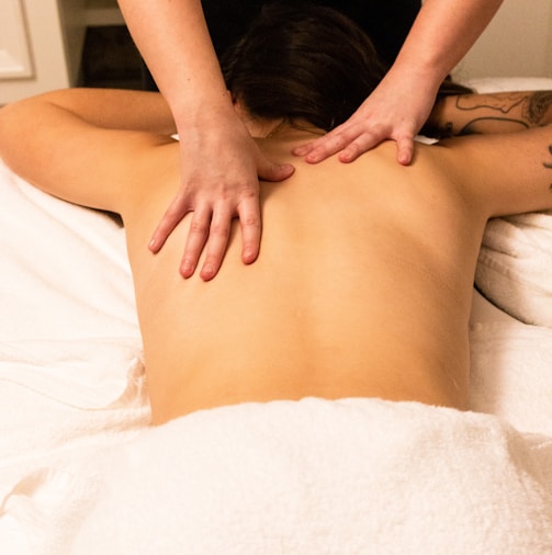 a woman getting a back massage at a spa