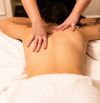 a woman getting a back massage at a spa