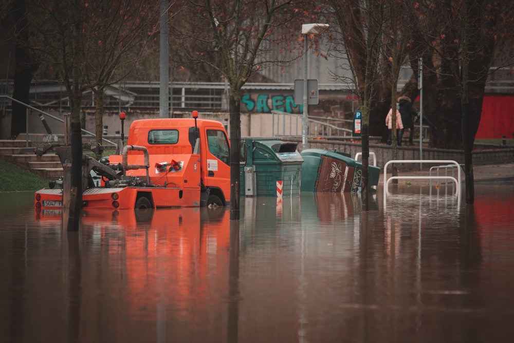 a truck is parked in a flooded street