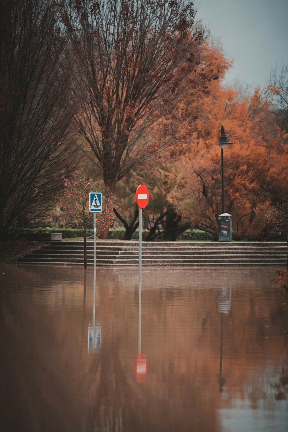 a red stop sign sitting on the side of a road