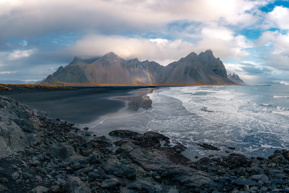 a beach with a mountain in the background