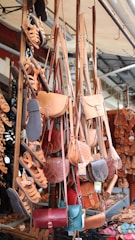 a bunch of purses hanging up in a store