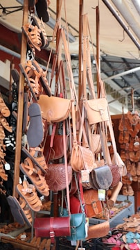 a bunch of purses hanging up in a store