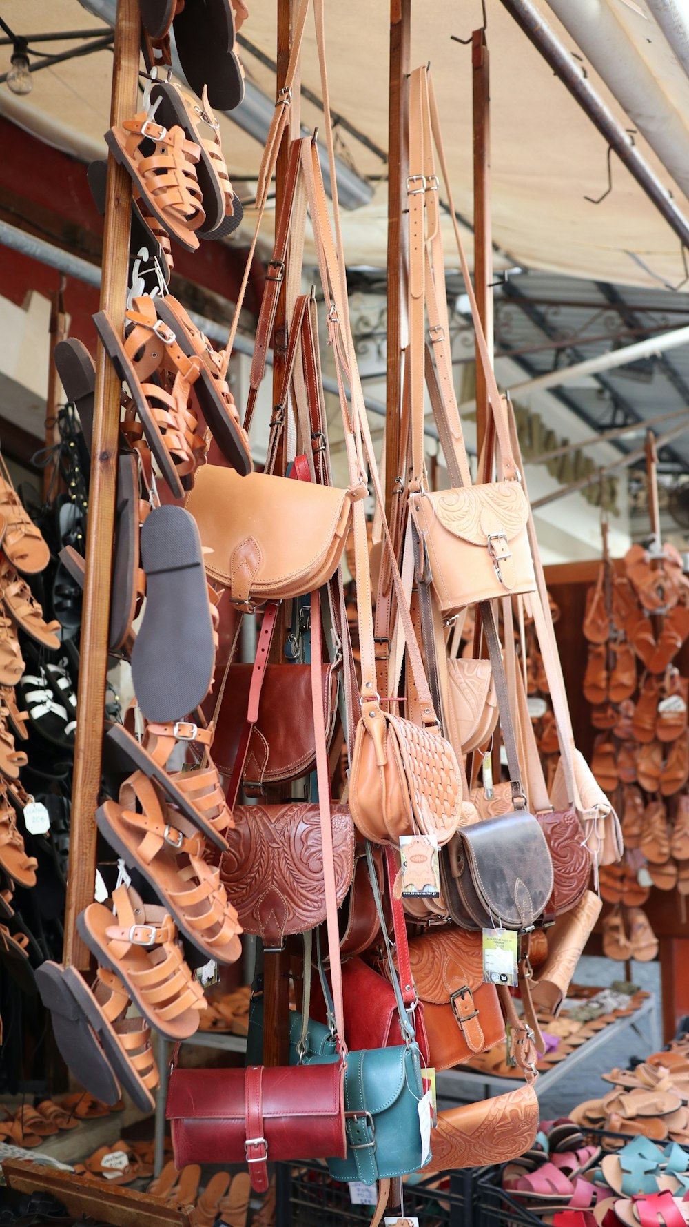 a bunch of purses hanging up in a store