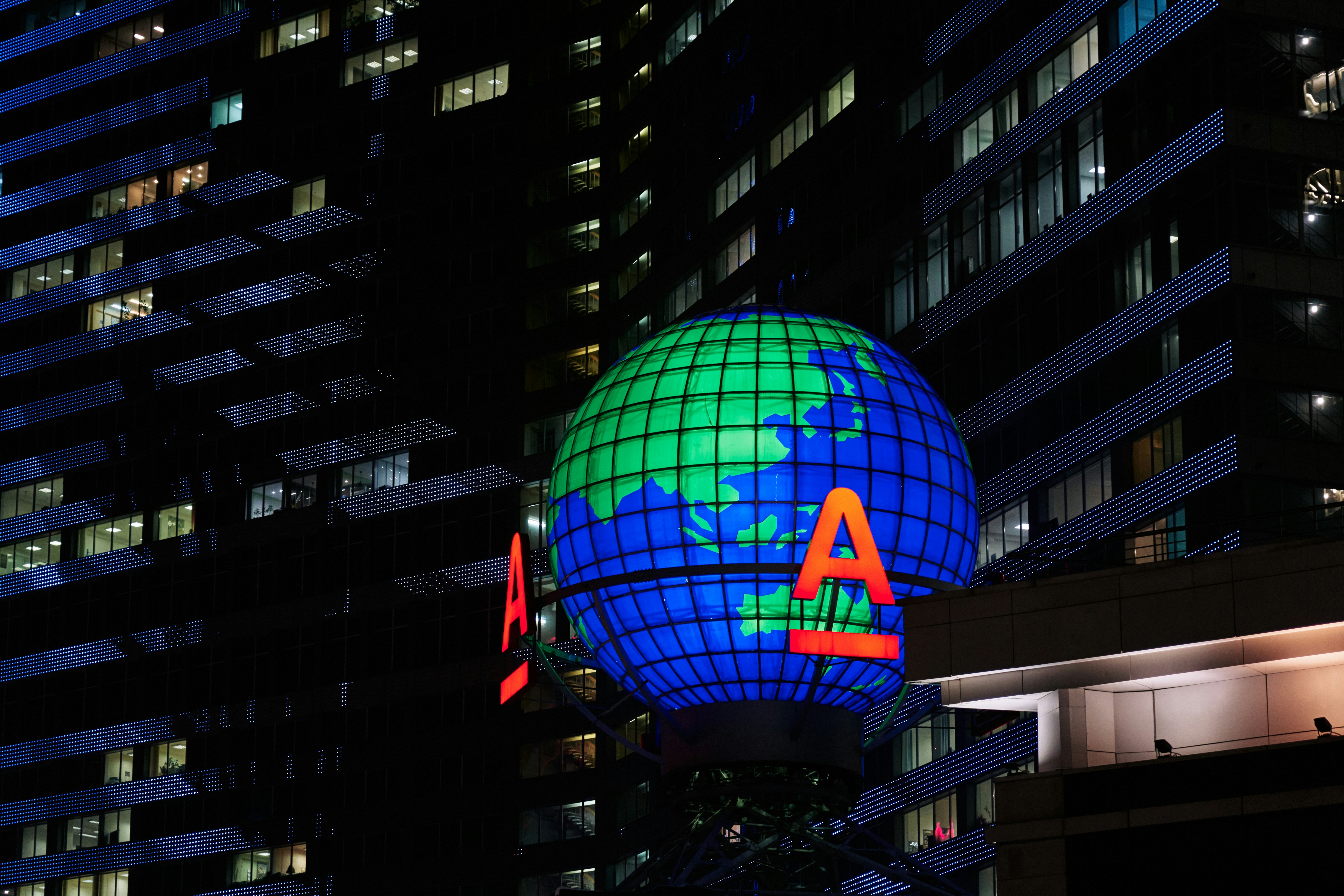AI technology investment bubble - a large globe with the letter a on it in a city at night