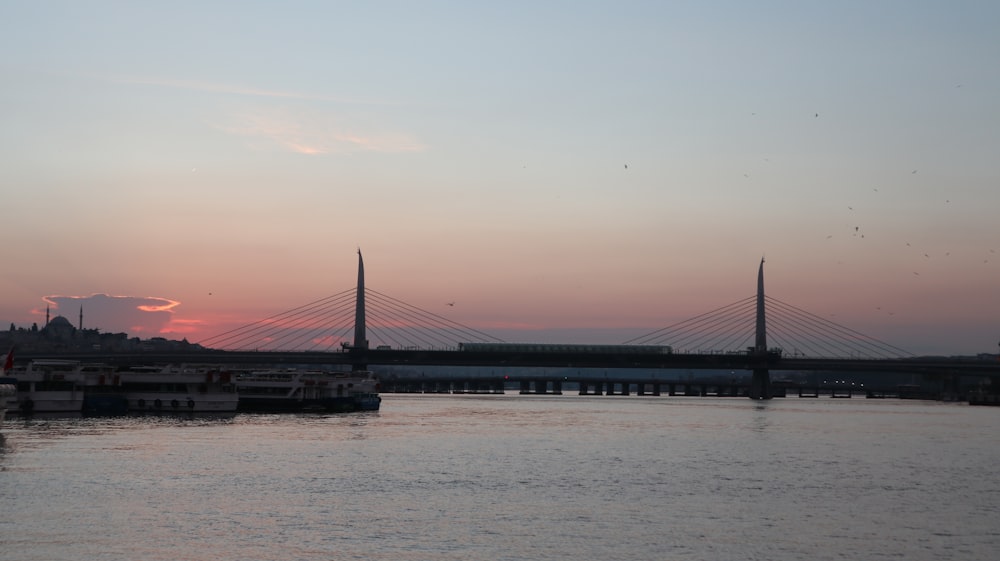 a bridge over a body of water at sunset