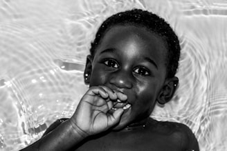 a black and white photo of a young boy